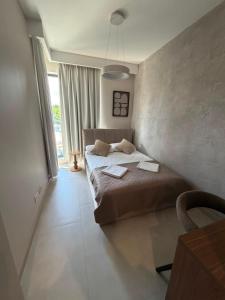 a bedroom with a bed with two towels on it at MJ Apartments in Łomża