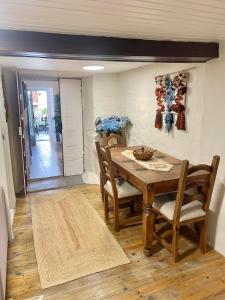 a dining room with a wooden table and chairs at Casa da Juana in Chantada