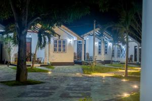 a house at night with a palm tree in front at Breeze 12 Villa in Negombo