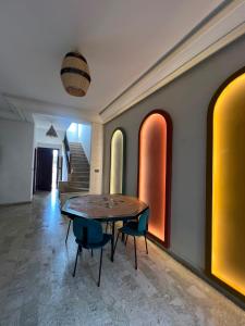 a dining room with a table and two chairs at Chic Villa - Pool - Wi-Fi -Parking - 3 Bedrooms in Sidi Bouzid