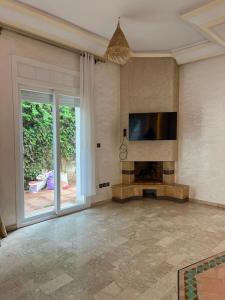 a living room with a flat screen tv on the wall at Chic Villa - Pool - Wi-Fi -Parking - 3 Bedrooms in Sidi Bouzid