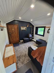 a living room with a bed and a couch at Linnansalmi Lakeside Villa with Sauna in Savonlinna