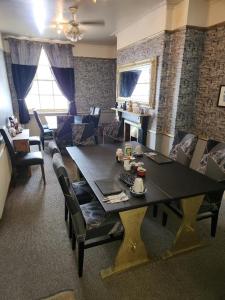 a living room with a large table and a couch at Spalite Hotel in Gloucester