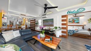 a living room with a couch and a bed at Spectacular luxury , modern oceanfront condo Maalaea-Kihei ,Maui in Wailuku