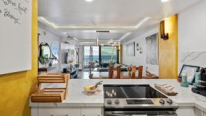 a kitchen and living room with a stove top oven at Spectacular luxury , modern oceanfront condo Maalaea-Kihei ,Maui in Wailuku