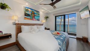 a bedroom with a bed and a large window at Spectacular luxury , modern oceanfront condo Maalaea-Kihei ,Maui in Wailuku