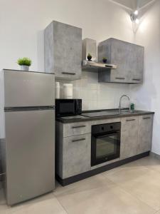 a kitchen with a refrigerator and a stove at Longhome in Pompei +20 photos