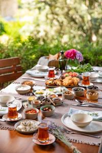 a table with plates of food on it at İda Blue Adatepe in Küçükkuyu