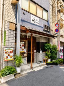 a store front of a building with a restaurant at Osaka Guesthouse Sakura in Osaka