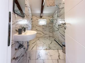 a bathroom with a sink and a shower at Seaside Village in Kamenari +40 photos