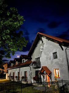 a white house with a fence in front of it at Cuib de Munte in Brezoi