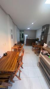 a room with wooden tables and chairs in a room at Hotel Santiago Juazeiro in Juazeiro do Norte