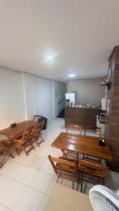 a room with wooden tables and chairs in it at Hotel Santiago Juazeiro in Juazeiro do Norte +9 photos