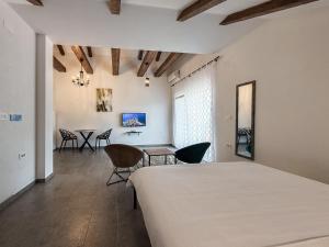 a bedroom with a bed and a table and chairs at Seaside Village in Kamenari