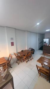 a group of tables and chairs in a room at Hotel Santiago Juazeiro in Juazeiro do Norte