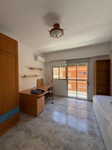 an office with a desk and a bed in a room at Zapillo 2&1 in Almería