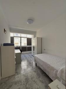 a bedroom with a bed and a desk and a window at Zapillo 2&1 in Almería