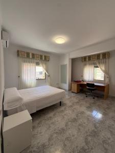 a bedroom with a bed and a desk in it at Zapillo 2&1 in Almería