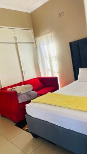 a bedroom with two beds and a mirror at Umthombo guest house in Mbabane