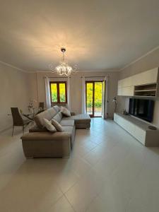 a large living room with two couches and a television at Respiro di luna in Pescopagano