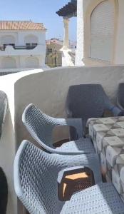a set ofvationvationvation chairs sitting on top of a building at Garden Beach 2 in Casablanca