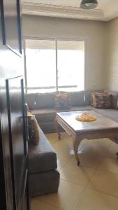a living room with a table and a couch at Garden Beach 2 in Casablanca