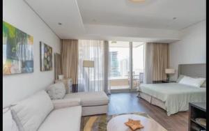 a living room with a bed and a couch at Syed Guest House in Karachi