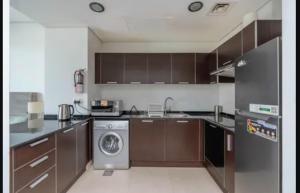 a kitchen with a washer and a dishwasher in it at Syed Guest House in Karachi