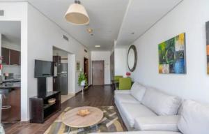 a living room with a white couch and a table at Syed Guest House in Karachi