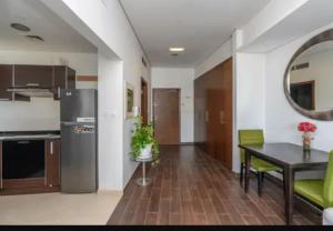 a kitchen and dining room with a table and a counter at Syed Guest House in Karachi