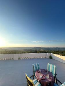 a table and chairs on the roof of a house at Respiro di luna in Pescopagano