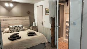 a bedroom with a bed with two towels on it at LA JARBELLE - Gîte et Spa in Les Orres +64 photos