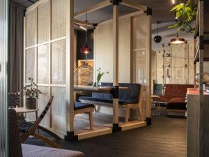 a living room with a table and a chair at Oru Hub Hotel Tallinn - Handwritten Collection in Tallinn