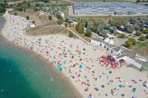 an overhead view of a beach with people with umbrellas at Unisotel Colmar Parc Des Exposition EX F1 in Colmar