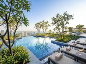 an infinity pool with chairs and trees on a building at Downtown Dubai's Highest Infinity Pool, Paramount Hotel Midtown in Dubai