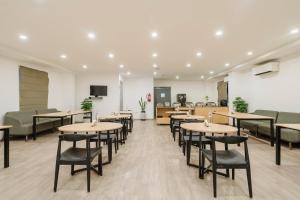 a restaurant with tables and chairs in a room at RCC Hotels Elite Begumpet in Hyderabad