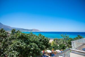 a view of the beach from the balcony of a house at Elia Suites in Falasarna