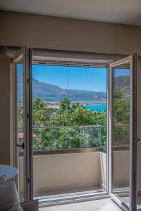 a room with a large window with a view at Elia Suites in Falasarna