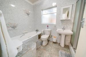 a bathroom with a toilet and a sink and a bath tub at 3 Italeni in Secunda +30 photos