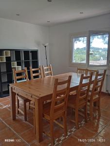 a dining room with a wooden table and chairs at Private pool and garden in Cunit