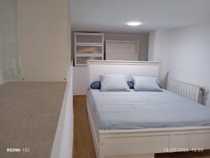 a bedroom with a white bed with blue pillows at Private pool and garden in Cunit +44 photos