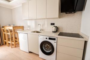 a kitchen with a washing machine and a sink at Royal Batın Apart Otel in Trabzon +11 photos