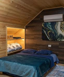 a bedroom with two beds in a room with wooden walls at Bar Restorant Geshtenja in Reç +45 photos