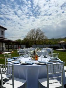 a long white table with white chairs and tablesearcher at Boutique Hotel Ilitsa in Gavril Genovo