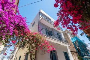 a building with pink flowers in front of it at DownTown Hotel in Nafplio