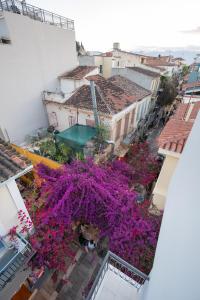 an aerial view of a city with purple flowers at DownTown Hotel in Nafplio +48 photos