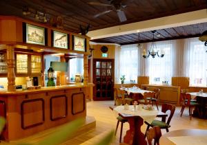 a restaurant with tables and chairs and a kitchen at Traditions - Hotel "Zur Tanne" in Wernigerode