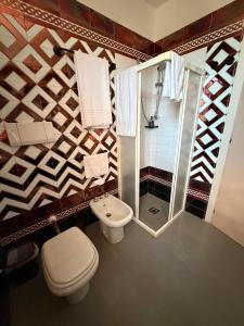 a bathroom with a toilet and a shower at Hotel l'etoile de la ville in Montecatini Terme