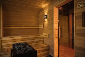 a sauna is shown with a wooden wall at Baltic Season Spa Apartments in Grzybowo