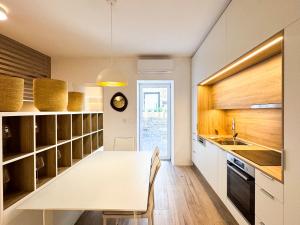 a kitchen with a white table and a dining room at Gloria Holiday - Villa di Istria in Piran